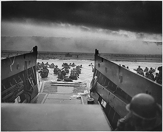 June 6, 1944 – U.S. troops face the fire of Omaha Beach, embodying the courage that turned the tide of WWII
